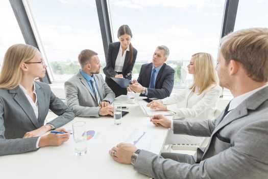 Business people team at meeting working documents together in office