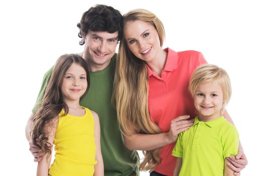 Studio portrait of family in colorful clothes with two children isolated on white background