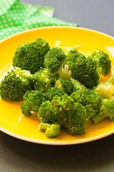 Fresh broccoli cut in yellow plate healthy natural clean food vegetable on wood background