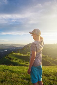 Young explorer at the sunset in Altai mountains