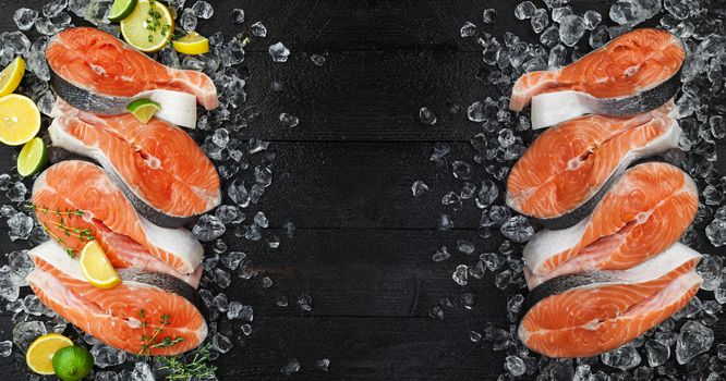 Fresh salmon steaks on ice, on black background. Top view, copy space