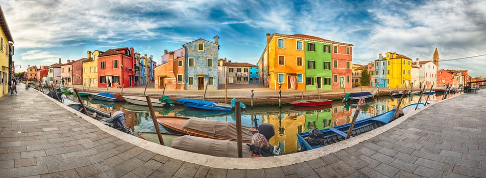 Panoramic view of the colourful houses along the canal on the island of Burano, Venice, Italy. The island is a popular attraction for tourists due to its picturesque architecture