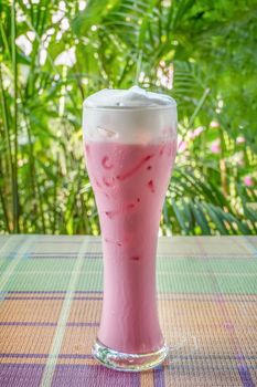 iced strawberry milk  on table with nature background