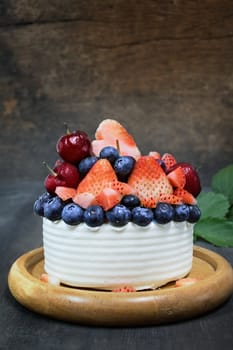white cake with fresh mix berries on top