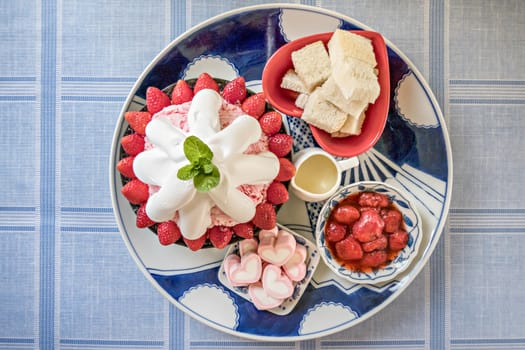 top view of Bingsu on tray served with mix  sweet topping , fruits and baked