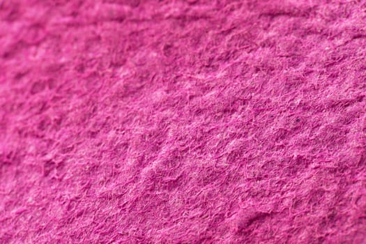 Close-up of a pink recycled paper. Macro texture.