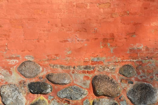 Ancient brick wall with big stones as background