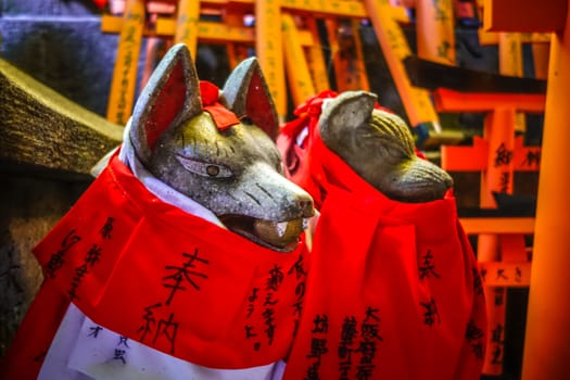 Fox statues at Fushimi Inari Taisha torii shrine, Kyoto, Japan