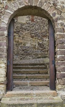 old wall with door entrance with staircase