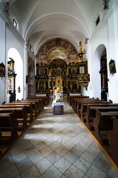 Rich decorated interior of a church in Olimje, Slovenia, with altar paintings and carved, golden plated statues