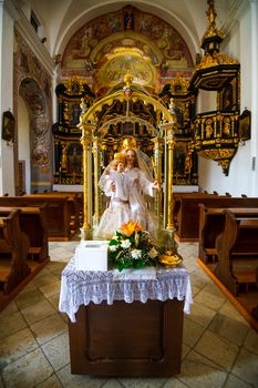 Rich decorated interior of a church in Olimje, Slovenia, with altar paintings and carved, golden plated statues