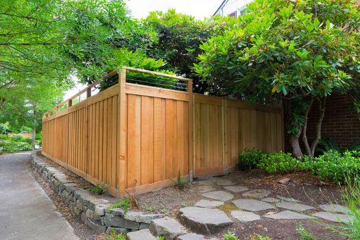New Cedar Wood Fence with gate door on home side yard landscaping