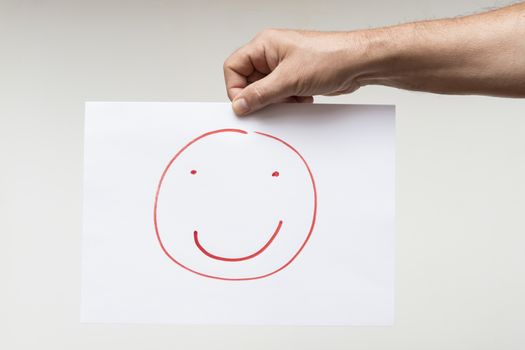 a sheet of paper with a drawing of a smiling face