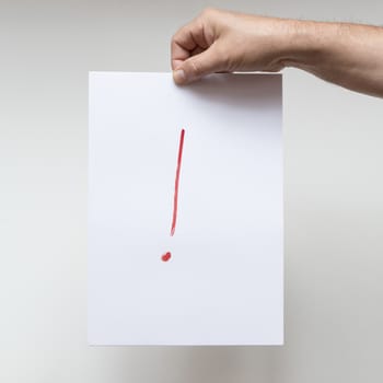 an exclamation mark on a sheet of white paper