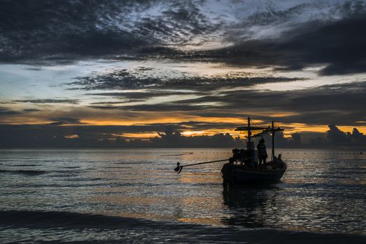 A beautiful tropical dawn with a fishing boat.