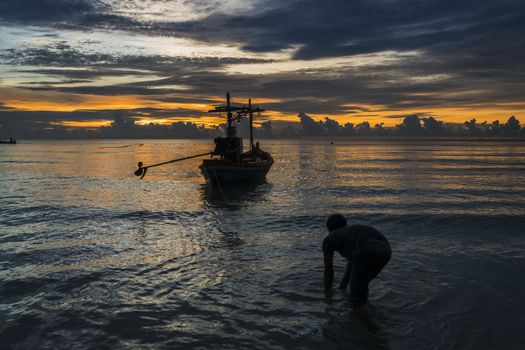 Fisherman prepare to work in dawn.