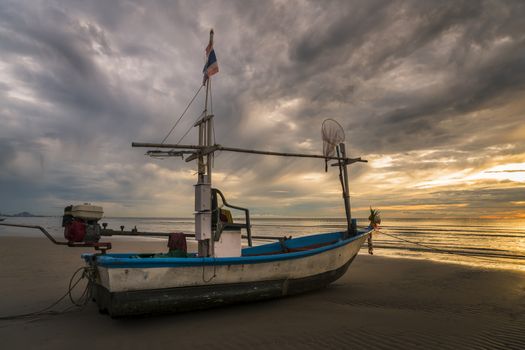 Fish boat rest on a beach in dawn