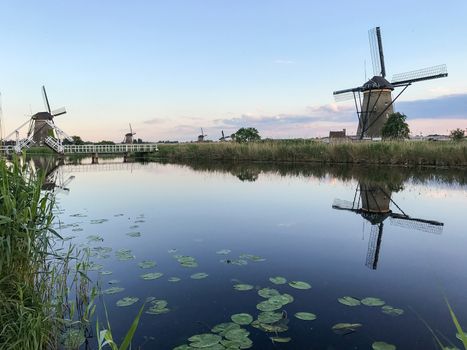 Beautiful dutch windmill landscape at the famous Kinderdijk canals, UNESCO world heritage site