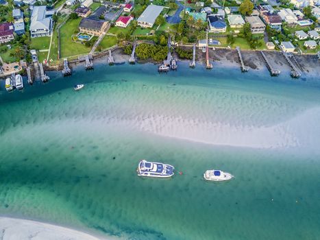 Boats moored in the channel showing the sand bars and sand patterns at low tide.