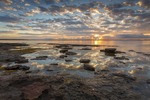 Beautiful sunrise reflecting across the bay at low tide.  Location  Callala Bay, part of Jervis Bay, Australia