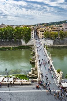 View of people walk on St Angel Bridge (Ponte Sant' Angelo) from Castel Sant'Angelo (Castle of Holy Angel) in Rome city