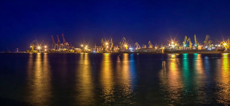 ODESSA, UKRAINE - 06.19.2018. Panoramic view of sea port and cargo terminal from the side of the sea terminal at summer sunset