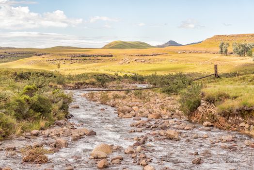 A pedestrian bridge over the Mlambonja River at the start of the three Pools hiking trail at Garden Castle in the Drakensberg