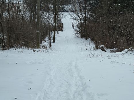 Countryside road covered with a lot of snow during winter