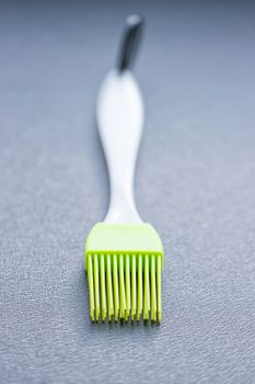 green silicone pastry brush on the blue background