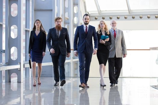 Business team walking in modern glass office building