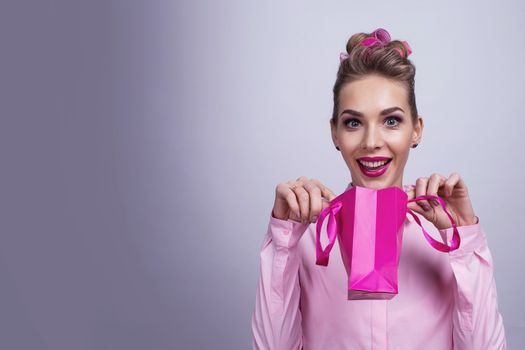 Shopping, sale, christmas and holiday concept - smiling woman with small shopping gift bag