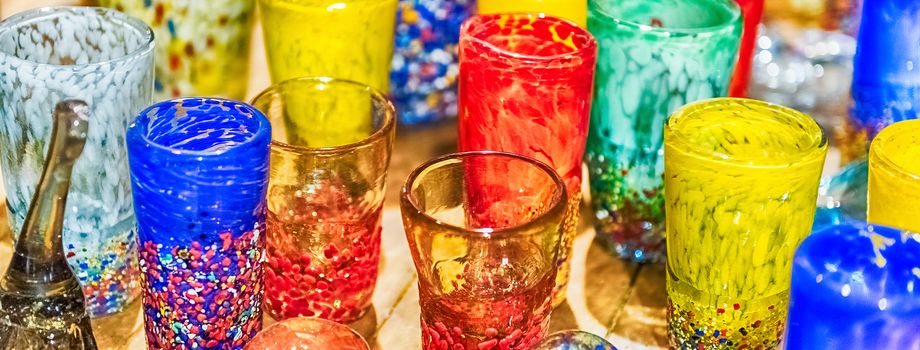 Traditional colorful murano glass goblets for sale in Murano island, Venice, Italy. The island is a popular attraction for tourists, famous for its glass making