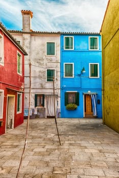 Traditional colourful painted houses on the island of Burano, Venice, Italy. The island is a popular attraction for tourists due to its picturesque architecture