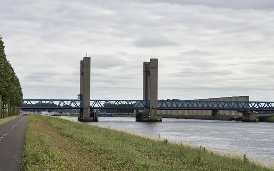 Caland Bridge (Calandbrug) a steel vertical lift bridge for rail, road and slow traffic in the Rotterdam port area. Large windshield of concrete slabs at the right