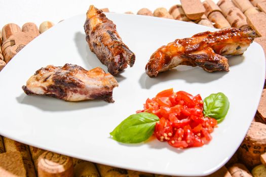Italian ribs cooked on the grill and seasoned with cherry tomatoes