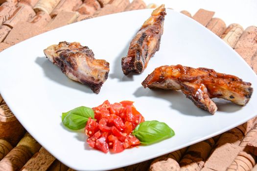 Italian ribs cooked on the grill and seasoned with cherry tomatoes