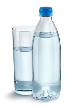 Glass with water and a plastic bottle. Closed plastic bottle. Isolated on white background.