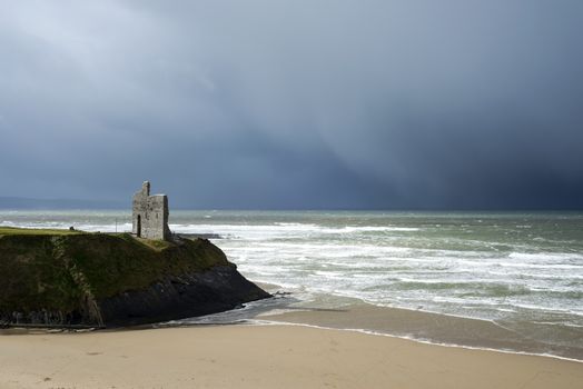 winter rain storm approaching ballybunion beach and castle