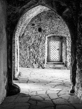 Ancient gothic arches in castle ruins. Black and white image.