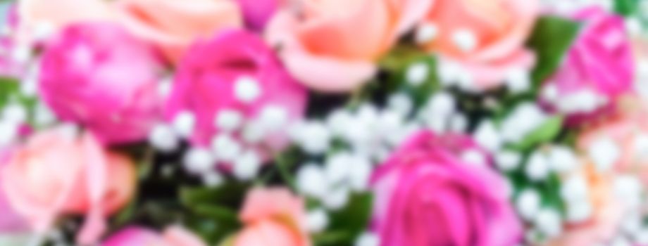 Defocused background with bouquet of roses. Intentionally blurred post production for bokeh effect