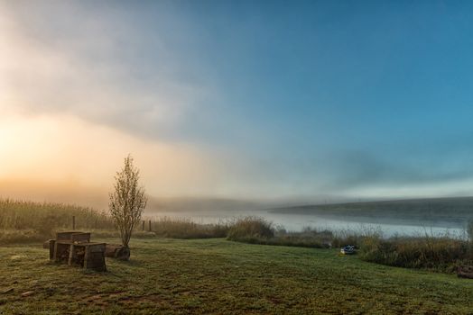 Sunrise at the dam at Tortoni near Maclear in the Eastern Cape Province. A canoe is visible