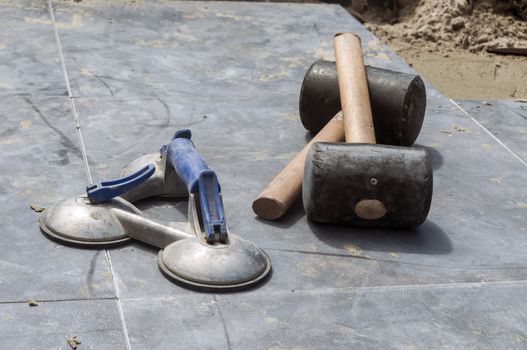 paving tools such as rubber hammers and handles with suction cups