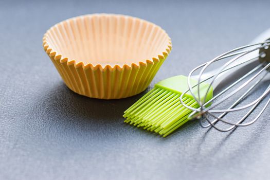 Rainbow silicone confectionery utensils on a blue background