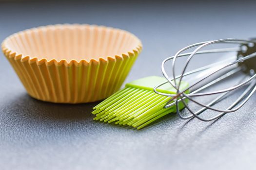 Rainbow silicone confectionery utensils on a blue background
