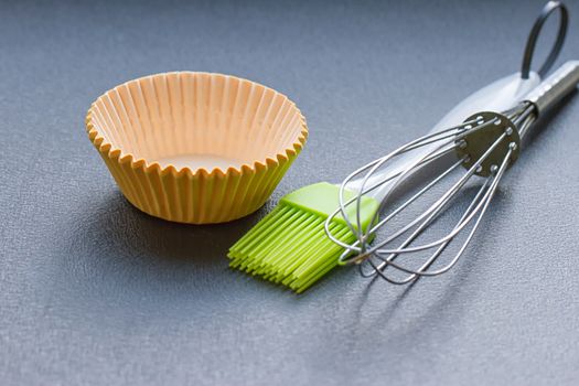 Rainbow silicone confectionery utensils on a blue background