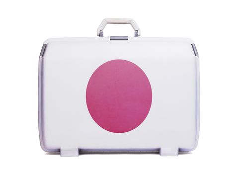 Used plastic suitcase with stains and scratches, printed with flag - Japan