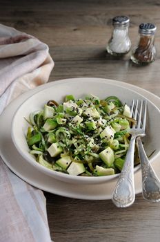 Salad from noodles from cucumbers and laminaria, slices of avocado with sesame