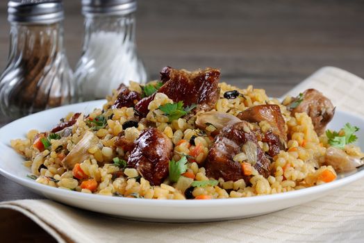 Pilaf   from bulgur with meat, vegetables and barberry