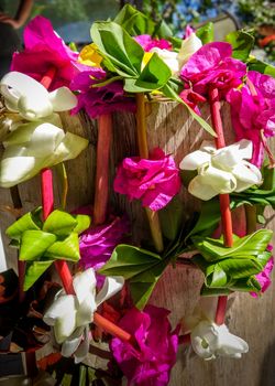 Traditional polynesian flower necklace on a wooden background