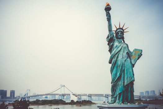 Statue of liberty, rainbow bridge and tokyo cityscape, Japan